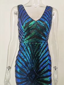 Detail showing high-density blue and green sequins with radial geometric pattern on deep V-neck dress