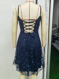 Detailed back view of navy blue prom dress showing lace-up corset and leaf embroidery