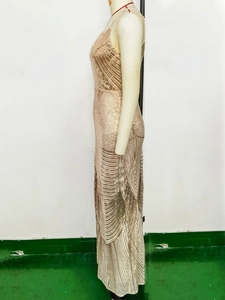 Detail view of champagne gold sequins in a geometric pattern on a slim fit evening gown