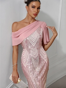 Detailed close-up of pink and gold sequins with elegant chiffon shoulder drape on dress