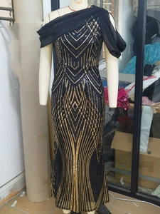 Detailed view of sequin geometry pattern and chiffon shoulder drape on evening gown