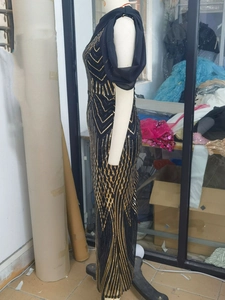 Detail of sequin geometric stripes on a black mermaid evening dress with tulle trim