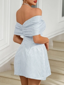 Detail of light blue off-shoulder dress with floral jacquard texture and V-back design