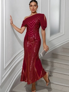 Detail of burgundy sequin evening gown with gold geometric patterns and one-shoulder design