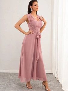 Detailed view of dusty pink chiffon maxi dress with deep V-neck and waist tie bow design