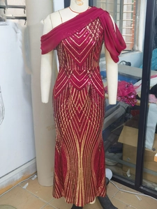 Detail of burgundy evening gown with V-pattern sequins and one-shoulder chiffon drape