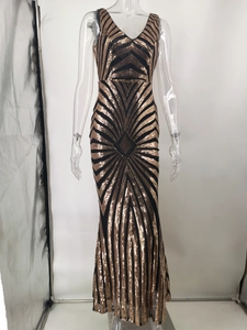 Detailed view of deep V-neck and Art Deco gold sequins on black evening gown
