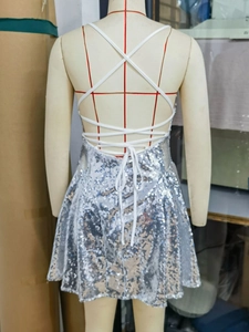 Detailed back view of sexy backless silver sequin dress with white criss-cross straps