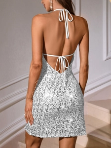 Detailed back view of a silver sequined backless mini dress with shiny halter neck design