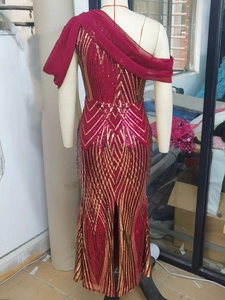 Detail of red sequin evening gown featuring one-shoulder chiffon drape and fish-tail cut