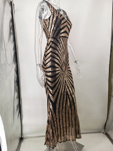 Detail of elegant backless sequin dress with gold geometric patterns and V-neck line
