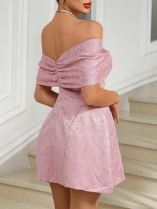Close-up of pink off-the-shoulder dress featuring floral jacquard and ruched back detail
