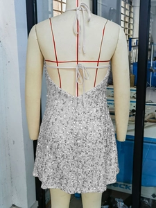 Detail of silver sequin backless mini dress with adjustable drawstring neck ties