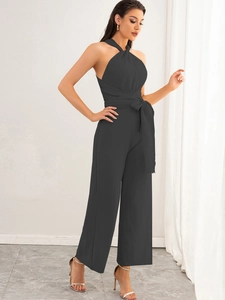 Detail view of dark grey wide-leg jumpsuit showing halter neck and textured fabric