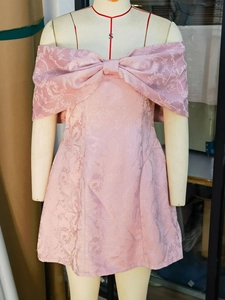 Pink off-shoulder cocktail dress with floral jacquard texture and large bow decoration