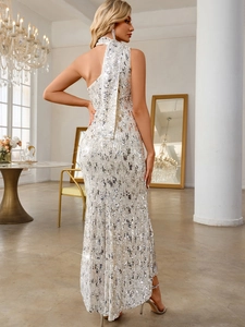 Detailed back view of a silver sequined fisheye evening gown with one-shoulder drape