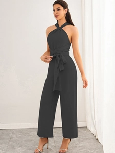 Detailed front view of a dark grey halter neck jumpsuit with an elegant waist tie belt