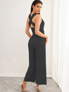Chic black halter backless jumpsuit with high waist wide leg pants for a sleek summer look
