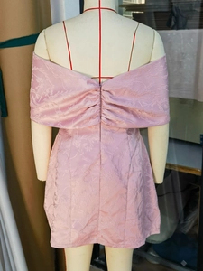 Detail of pink floral jacquard fabric and hidden zipper on back of the dress