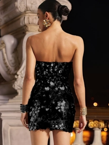 Close-up of the shimmering black sequins and backless fit of this sexy mini cocktail dress