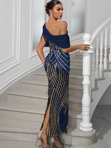 Detail view of shimmering blue and gold sequin stripes on a one-shoulder evening gown