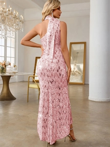 Detail view of the shimmering pink sequins and sleek open back on this mermaid evening gown