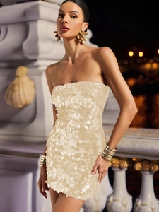 Close-up of champagne gold circular sequins on a slim fit strapless mini dress