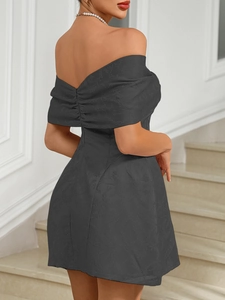 Detail of off-shoulder dark grey mini dress featuring 3D floral jacquard textured fabric