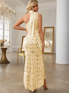 Close-up of luxury gold sequin mermaid dress with elegant one-shoulder neck tie detail