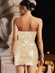 Detailed back view of a champagne gold sequin mini dress with backless design and metallic finish
