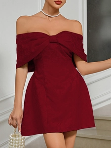 Detail of burgundy off-shoulder cocktail dress with bow and floral jacquard texture