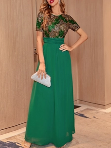 Close-up of the elegant sequin bodice and flowing green chiffon skirt on this evening gown