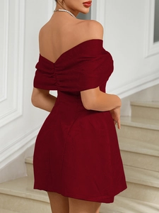 Close-up of dark red off-shoulder cocktail dress featuring intricate floral jacquard fabric