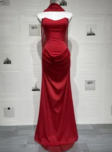 Detail of red satin strapless evening gown with draped waist and long matching shawl