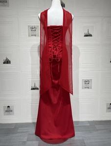 Detail of red evening gown with vintage corset lace-up back and sheer mesh shawl