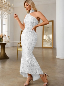 Detail of white sequin mermaid dress with elegant one-shoulder neckline and luxury texture