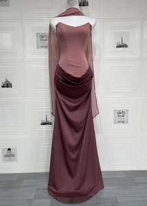 Detail of elegant dusty pink satin formal gown with waist pleats and long streamers