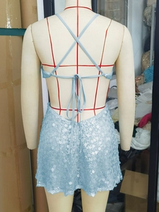 Detailed back view of a light blue sequin dress with adjustable crisscross lace-up straps