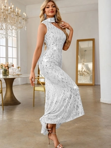 Detail showing shimmering silver sequins and elegant one-shoulder draping on the dress