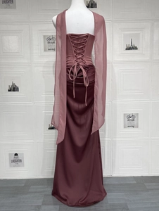 Detail of elegant back lace-up closure on satin evening dress with tulle shoulder drapes