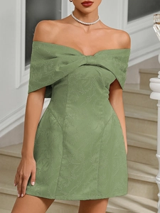 Detail of sage green off-shoulder cocktail dress with jacquard fabric and large bow