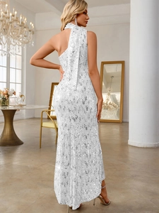 Detailed view of silver sequin one-shoulder evening gown with long scarf-style streamer