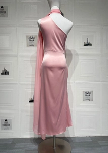 Detail of pink satin halter dress showing elegant side ribbon and smooth silky fabric