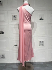 Detail of pink satin evening dress showing glossy fabric texture and flowing neck scarf