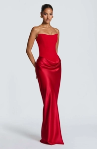 Detail of red strapless satin gown showing waist pleats and luxury fabric texture