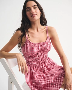 Close-up of strawberry print on red gingham smocked dress for women's summer style