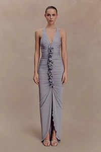 Deep V-neck ruched maxi dress detail with 3D floral accent and elegant split hemline
