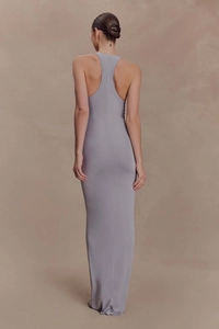 Rear view of tight gray sleeveless maxi dress showing open back design and slim fit cut