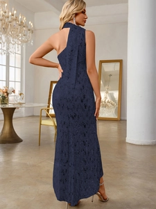 Detail of navy blue sequin evening dress showing one-shoulder backless design and texture
