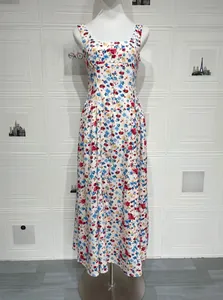 Detail of white floral maxi dress featuring intricate lace trim on the round neckline